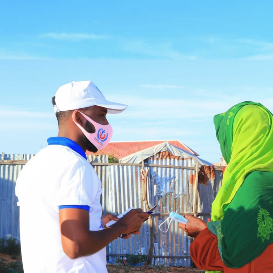 A KPHF enumerator recording information from a woman at an IDP site