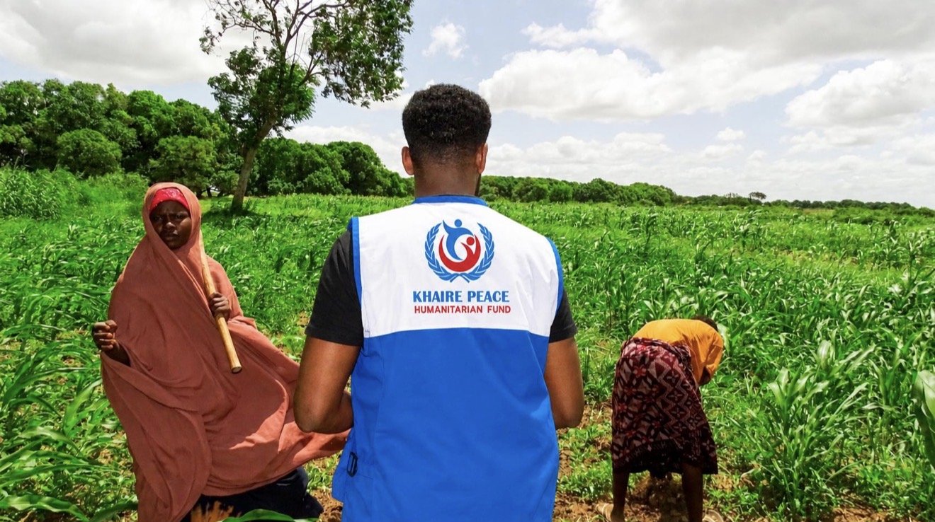 A KPHF officer with women farmers in a maize field
