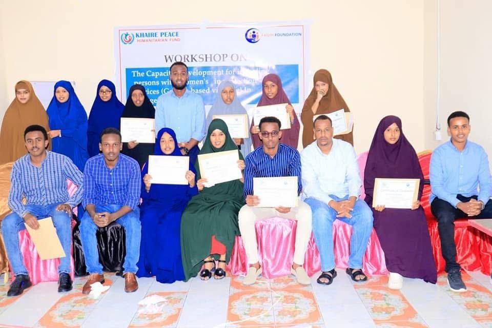 Young women and men holding certificates after completing a KPHF training